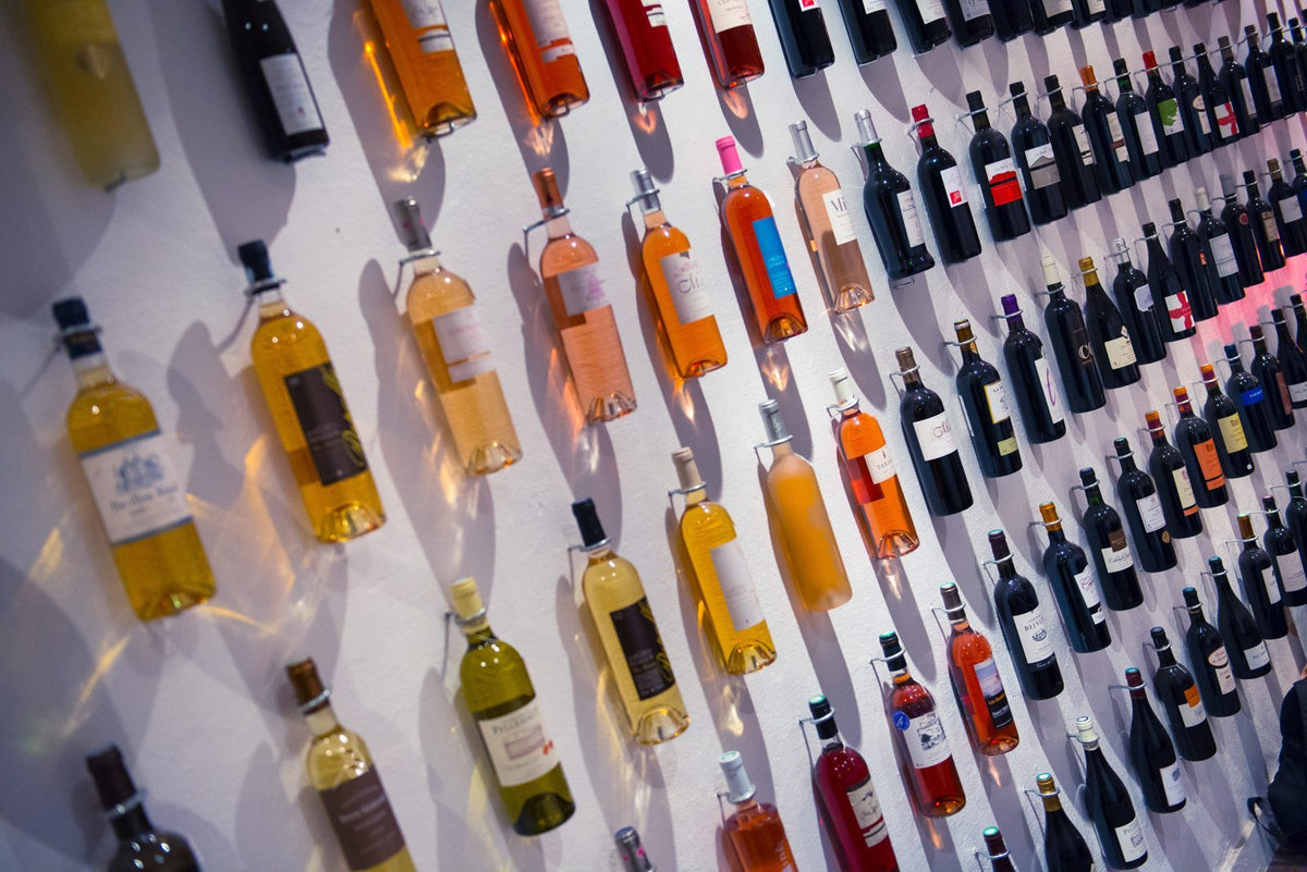Mur de bouteilles de vins blancs, rosés et rouges dans la cave Maison Sarment